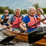 A senior group of friends enjoying rowing on the River Derwent